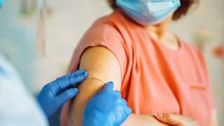 Medic applying plaster following vaccination