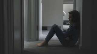 Young girl sitting on landing floor - negative emotion