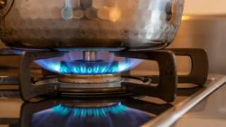 Saucepan on gas hob with flame turned on