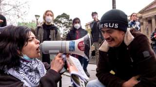 woman with megaphone shouting at man