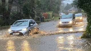 Cars drive through flood water on the Isle of Wight
