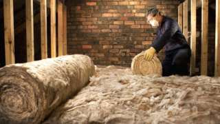 Man laying loft insulation
