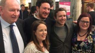 Ross McMullan (centre) celebrates with his Alliance colleagues in Belfast