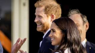Prince Harry, Duke of Sussex (C) and his wife, Meghan, Duchess of Sussex (R) arrive on the Yellow Carpet before the start of the Invictus Games in The Hague