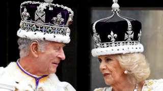 King Charles III and Queen Camilla speak on the balcony of Buckingham Palace, London, following their coronation on 6 May 2023