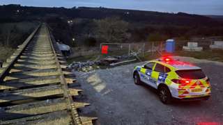 Train leading over quarry