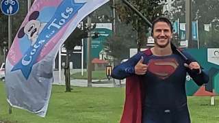 Tom Young dressed as superman on one of his runs