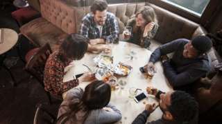 Six people drinking in a pub