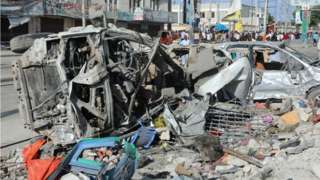 This photograph taken October 30, 2022 shows a destroyed cars after an car bombing targeted the education ministry in Mogadishu on October 29, 2022