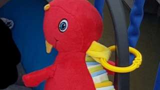The red toy dinosaur that belonged to the baby