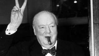 Winston Churchill gives his familiar and famous V for Victory sign after a lunchtime meeting, at 10 Downing Street