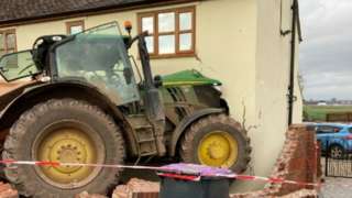 tractor crashed through house