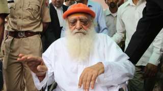 Spiritual leader Asaram Bapu accused in a sexual assault case arrives on wheel chair at the district session court for hearing.