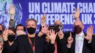 Delegates pose for a picture during the UN Climate Change Conference (COP26) in Glasgow, Scotland