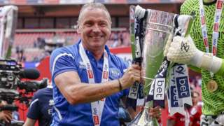 Paul Simpson with the play-off trophy