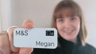Megan Tomkies holding the new badge