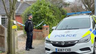A police man and a police car outside a property in The Warren, Cromer. Norfolk