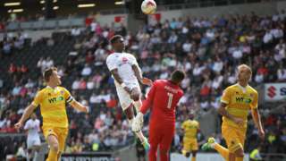 Kieran Agard of MK Dons heads in his teams equaliser during the Sky Bet League One match between Milton Keynes Dons and Millwall at StadiumMK