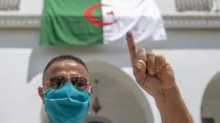 An Algerian man living in Tunisia casts an early vote on Friday, ahead of Saturday's election.