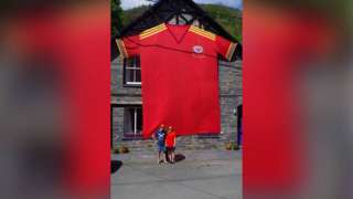 the giant shirt hanging on the front of the house