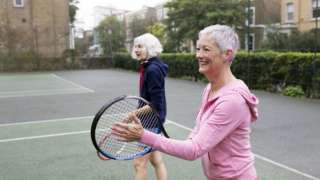 two women playing tennis