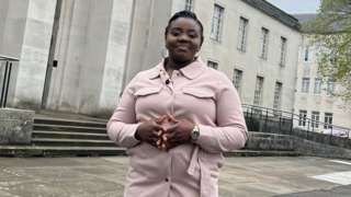 Evelyn James standing in front of the Temple of Peace in Cardiff.