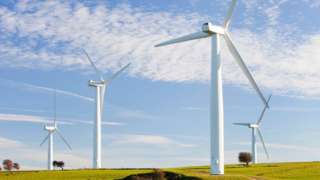 A wind farm on the outskirts of the Lake District with Skiddaw behind, Cumbria