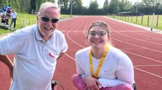 Coach Bob and frame runner Charlie smiling for a photo