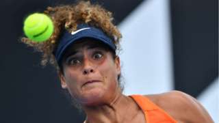 Mayar Sherif stares intently at the ball as she hits a return.