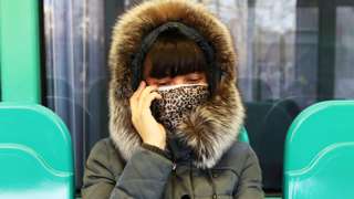 Woman with a mask on a train