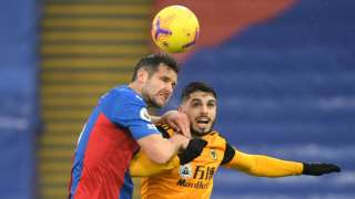 Scott Dann of Crystal Palace and Pedro Neto of Wolverhampton Wanderers