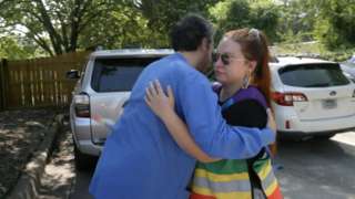 Escorts hug staff on the last day of Little Rock Family Planning Services