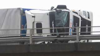 A lorry seen on its side on the M4 during storm Eunice on 18 February 2022 in Margam, Wales