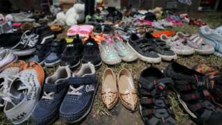 Children's shoes left at the base of a vigil