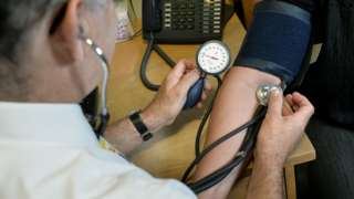 Doctor checking a patient's blood pressure