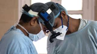 Members of an Indian surgical team perform an endoscopic surgery