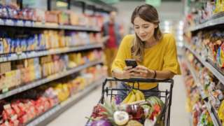 Stock image of a woman shopping in a supermarket
