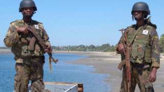 Mozambique soldiers stand at a port in Mocimboa da Praia, northern Mozambique, on August 12, 2021.