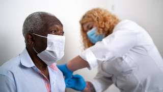 older black man being given vaccine