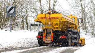 A gritter spreading salt on a road
