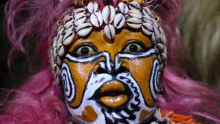 Senegalese people wearing traditional face paints and clothes perform dances from the Lebu ethnic group.
