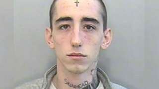 mug shot of tattooed man