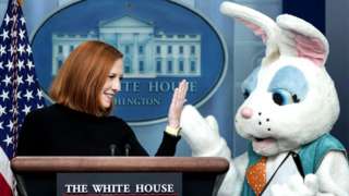 An Easter Bunny stands next to White House Press Secretary Jen Psaki as she delivers the daily briefing in the Brady Briefing Room of the White House in Washington, DC, US, on 18 April 2022