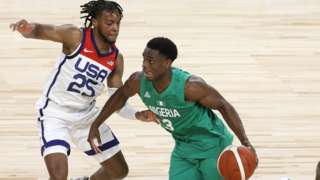 Nigeria basketballer Caleb Agada (right) takes on the USA's Darius Garland