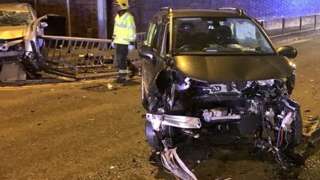 The scene of the crash with the two cars in the frame