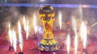 The World Cup trophy surrounded by pyrotechnics