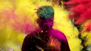 People throw coloured powder as they celebrate Holi, in Jodhpur, India, on 29 March 2021