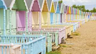 Soft pastel colored beach huts in West Mersea, Mersea Island, Essex