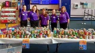 Cinema staff with some of the donated cans