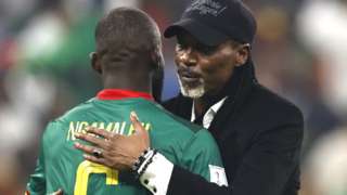 Cameroon coach Rigobert Song embraces defender Nicolas Ngamaleu